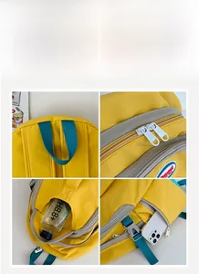 Detailed close-up of yellow nylon backpack showing zippers, side pockets and buckle straps