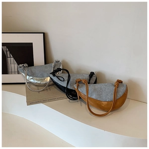 Detailed close-up of half-moon shoulder bags in tweed and leather with rope knot straps