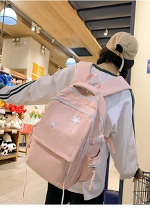 Pink waterproof nylon backpack featuring white star patch and Lucky Day embroidery detail
