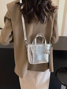 Silver metallic mini tote bag with top handles and adjustable shoulder strap for women
