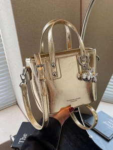 Metallic gold bucket handbag with handles and adjustable shoulder strap for women