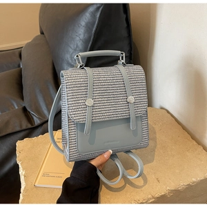 Detail of light blue and woven fabric mini backpack featuring silver round metal buckle