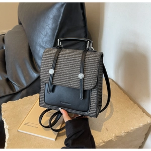 Detail of vintage plaid fabric and leather flap on a stylish women backpack