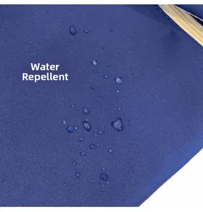 Water-resistant blue fabric detail of a large capacity backpack with water droplets