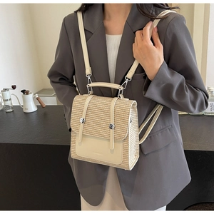 Detailed macro view of beige straw and leather backpack with silver metallic studs