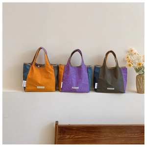 Detailed comparison of orange, purple, and green minimalist fabric shoulder bags