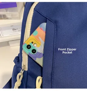 Detailed view of large capacity nylon backpack front zipper pocket for smartphone storage