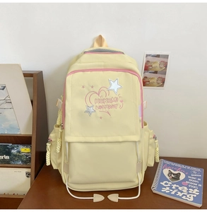 Close-up of light yellow nylon school bag with pink zipper and KEKEMI embroidery