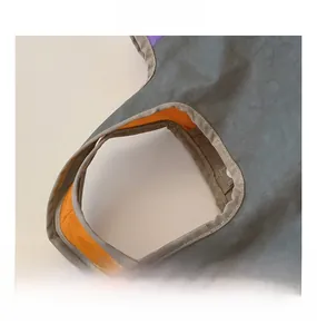 Detail of fabric tote handle with multi-color stitching and bright orange lining