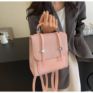 Detail of pink woven texture and smooth leather finish on a stylish women's backpack