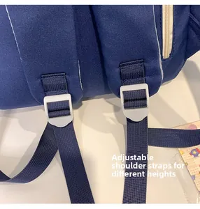 Detail of adjustable padded shoulder straps with white buckles on navy canvas backpack