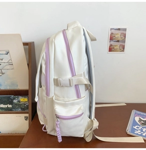 Detailed side view of white and purple ergonomic school backpack with side buckles