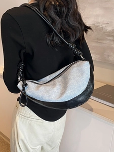 Light blue denim crescent bag with black leather trim and knot strap design