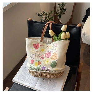 Dettaglio della borsa tote in tela e paglia con stampe graffiti colorate e manici in pelle
