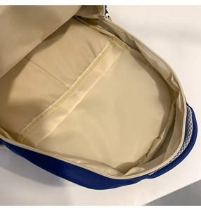 Detail of spacious interior with padded laptop compartment in navy casual backpack