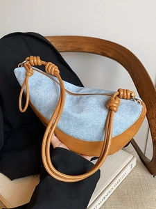 Blue denim and brown leather crescent bag with unique knotted rope shoulder strap handle