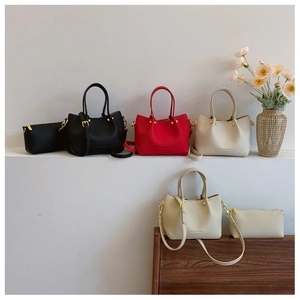Close-up of minimalist pebble leather bucket bags with gold-tone hardware and straps