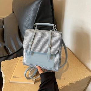 Light blue faux leather mini backpack with black and white woven texture flap detail