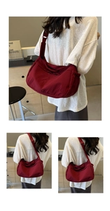 Detail view of burgundy crossbody bag with side drawstring design and adjustable strap