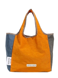 Three-color patchwork tote bag in blue orange and grey with unique wrinkled texture