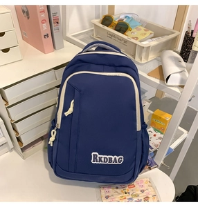 Detail of a large navy blue backpack on a desk showing wear-resistant nylon fabric