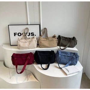 Multiple colors of large capacity nylon crossbody bags with adjustable straps and front pockets