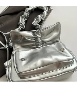 Detail view of silver PU shoulder bag with magnetic closures and scrunchie strap
