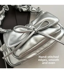 Detail of silver metallic handbag showing fine stitching and smooth leather texture