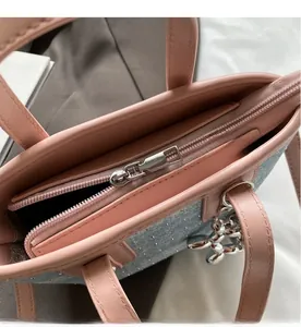 Detail view of pink bucket bag with smooth silver zipper and cute balloon dog charm