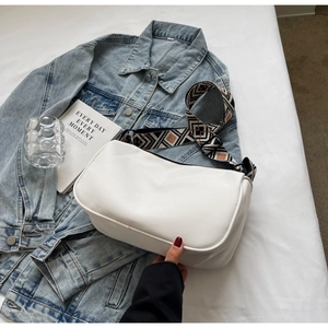 Detailed view of white PU leather shoulder bag with colorful geometric wide strap