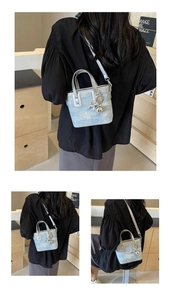 Light blue denim mini bucket bag with silver handles and balloon dog charm detail