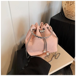 Detail of pink bucket bag with silver ring handle and delicate pearl drawstring charms