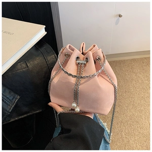 Detail of pink bucket bag with pearl drawstring tassels and a gold metal ring handle