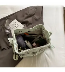 Spacious interior of mint green crocodile-pattern bucket bag showing ample storage