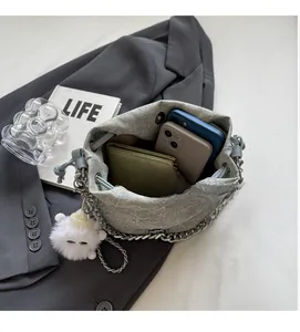 Top view of grey bucket bag showing interior capacity with phones, wallet and mints