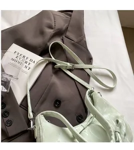 Detail of light green marble texture bag with adjustable shoulder strap and bow