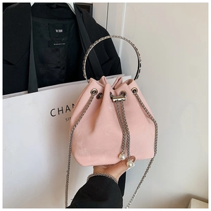Detail view of pink matte bucket bag with silver metal ring and large pearl drawstring