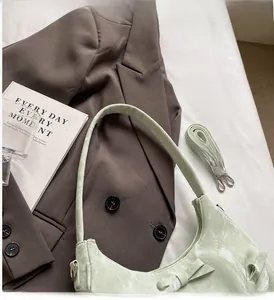 Detail of light green marble texture handbag with a bow and detachable shoulder strap