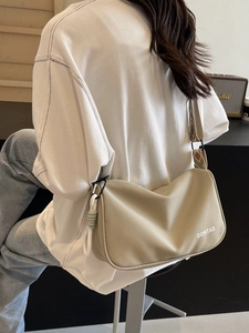 Minimalist beige crossbody shoulder bag with wide geometric strap and logo detail