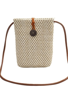 Minimalist straw woven crossbody phone bag with brown strap and wooden button
