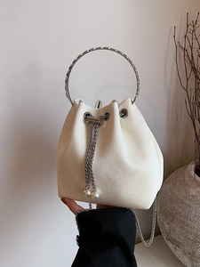 Minimalist beige bucket bag featuring silver ring handle and pearl chain drawstring design