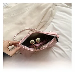 Detailed interior view of a pink quilted crossbody bag showing daily essentials storage