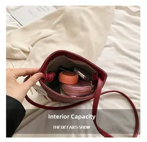 Interior view showing the large capacity of this elegant burgundy bucket bag