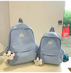 Light blue nylon backpacks in two sizes featuring cute bear logo and star keychain