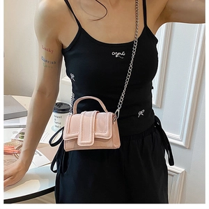 Detailed shot of a pink mini crossbody bag featuring a silver metal chain and top handle