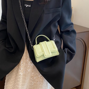Neon green crocodile texture mini crossbody bag with silver chain and top handle