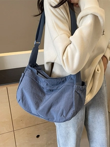 Minimalist grey-blue large capacity crossbody dumpling bag for women shown on model