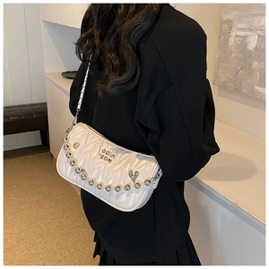 Side view of white quilted crossbody bag with silver chain and decorative bead handle