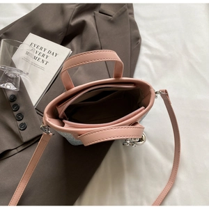 Detail view of pink handle contrast glitter bucket bag with multiple zipper compartments