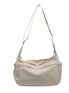 Minimalist beige dumpling crossbody bag with adjustable wide strap and side drawstrings